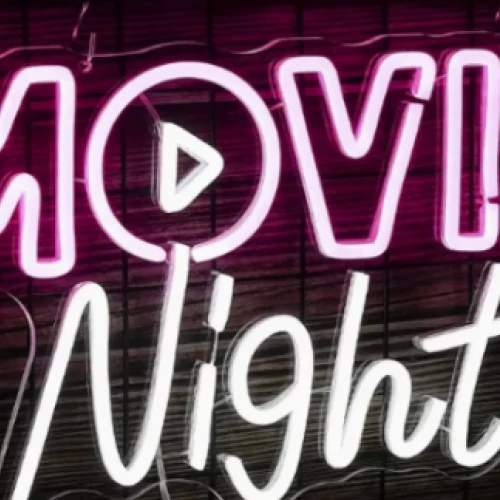 A neon sign that reads "Movie Night" with a play button in the "O" of "Movie."