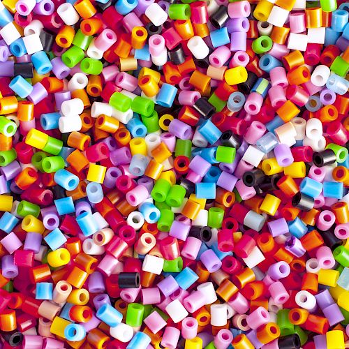 The image shows a pile of colorful, cylindrical beads scattered randomly.